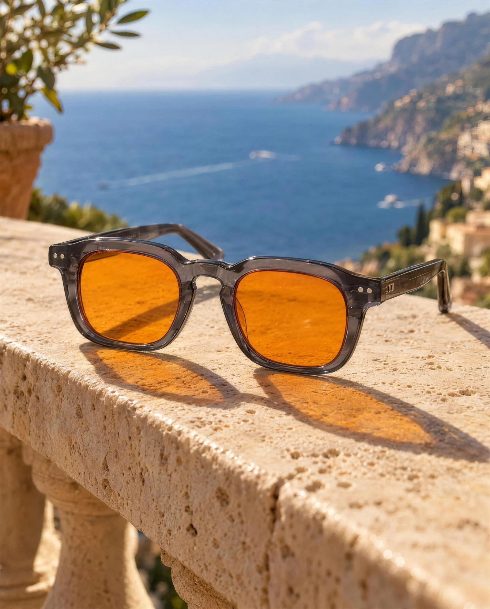 LUMIX glasses resting on a travertine balustrade above the sea